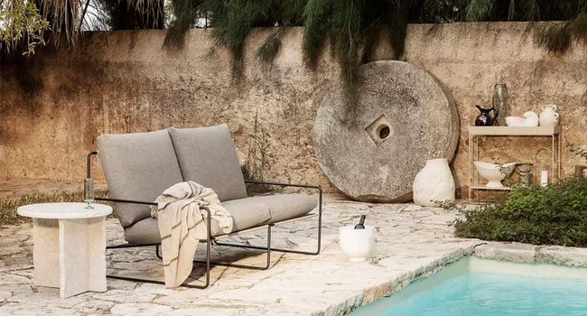 Ferm Living Desert Desert 2-Sitzer Sofa neben Swimmingpool